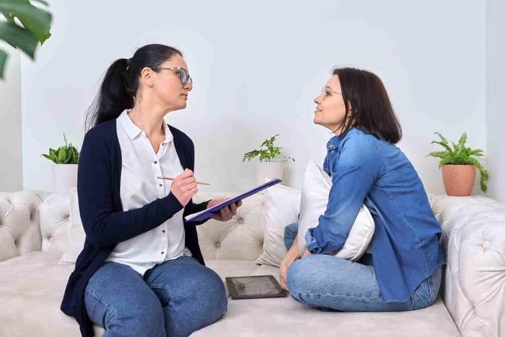 Woman talking to her therapist on a sofa